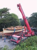 Toucando is craned out of the 'Tennis Court' where she was born.